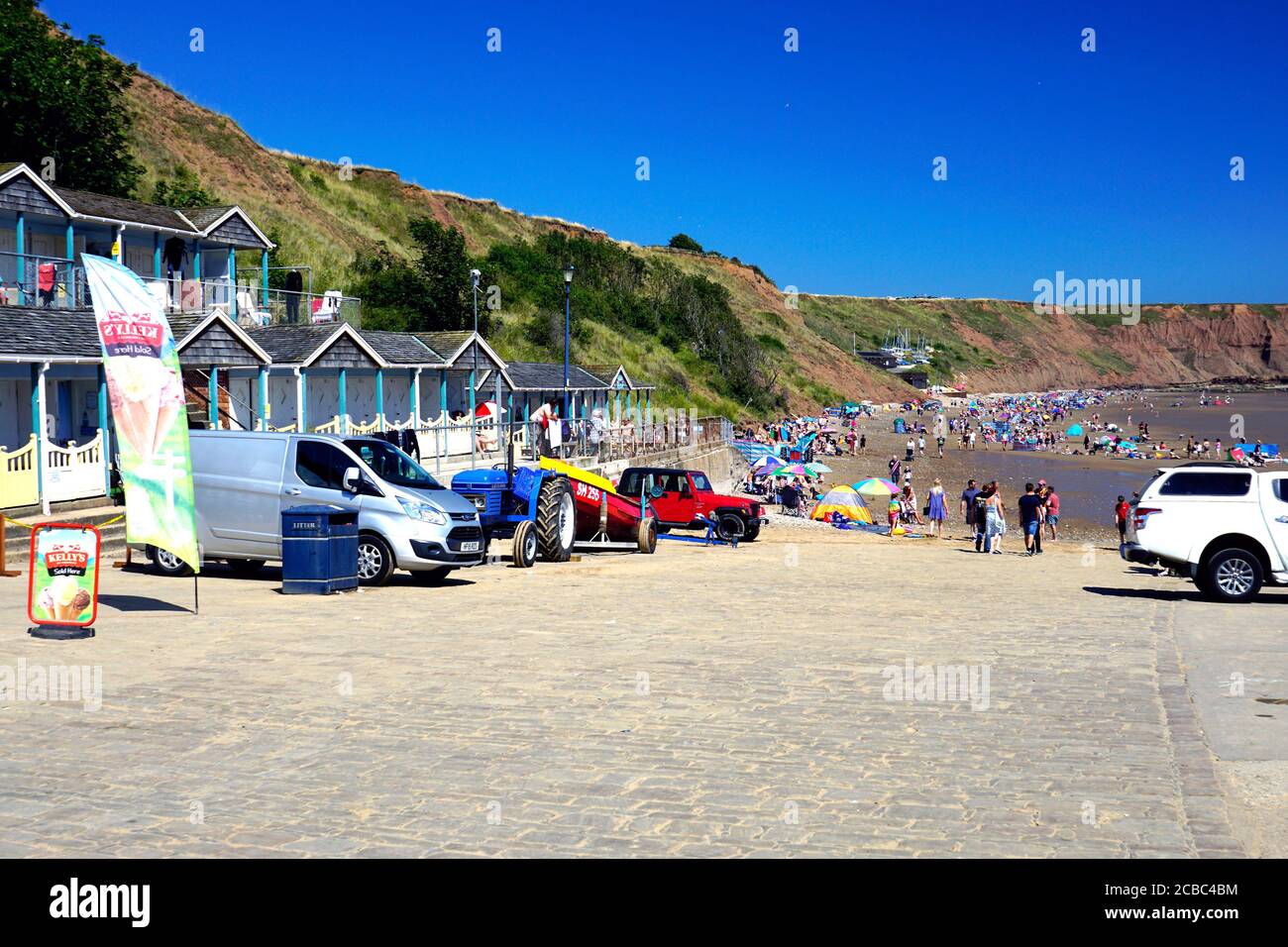 Filey, Yorkshire, UK. August 07, 2020. Holidaymakers enjoying the facilities and beach chalets after the Covid-19 lockdown on Coble landing at Filey i Stock Photo