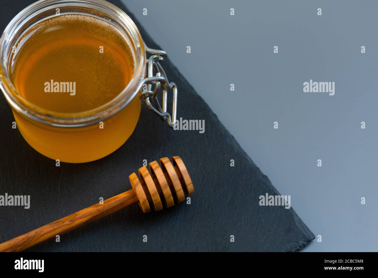 organic honey and rustic bread on a old wooden table. Healthy eating breakfast. Stock Photo