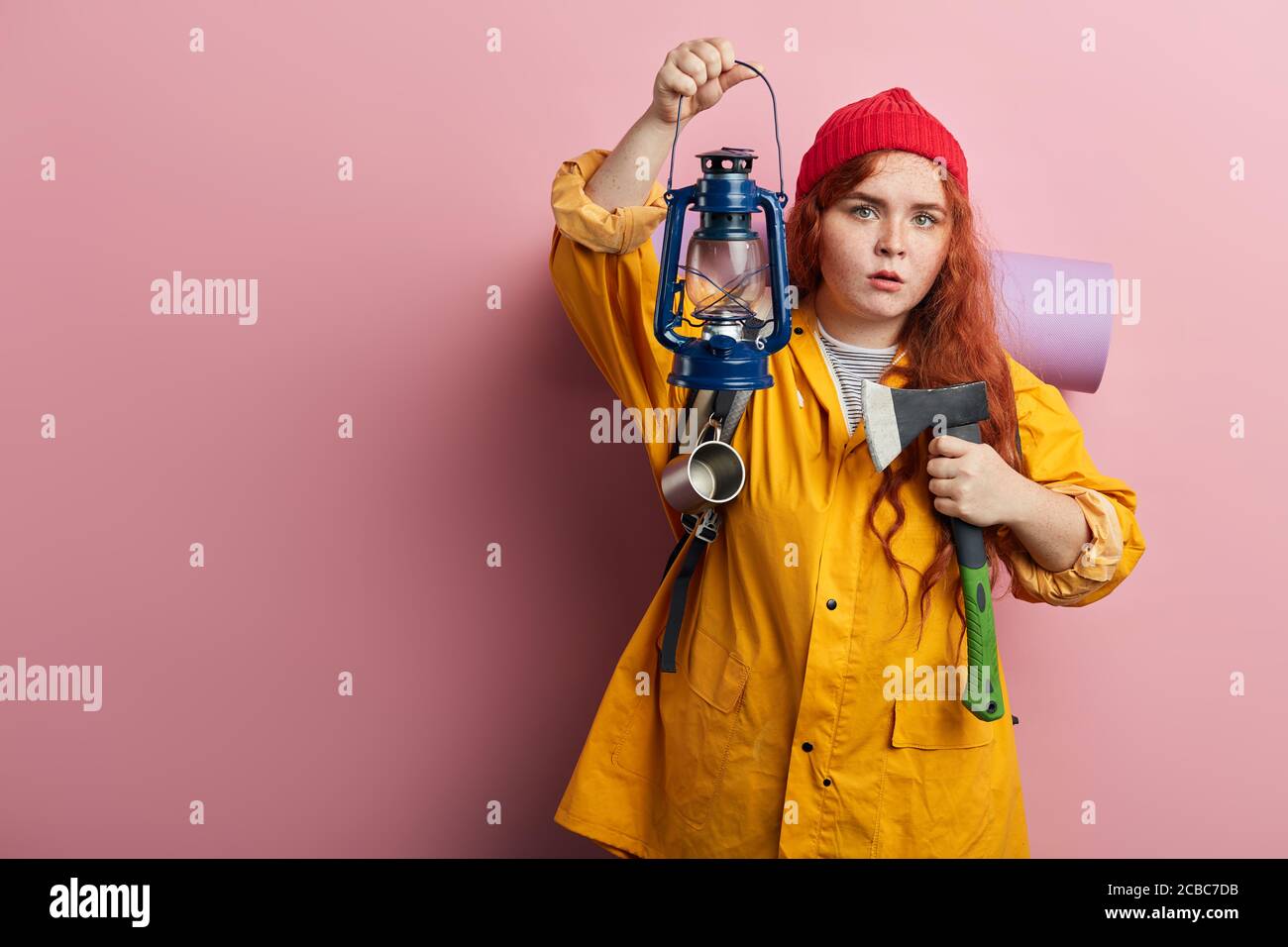 Toestemming parlement Mogelijk beautiful ginger frightened girl holding a lamp, axe while walking in the  forest. dangerous hobby, lifestyle.copy space. isolated pink background  Stock Photo - Alamy