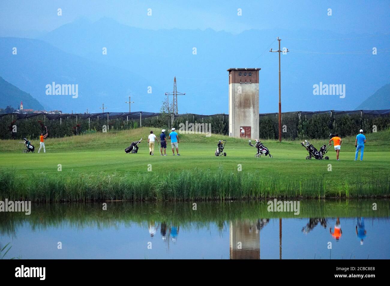 Group of friends - golfers enjoying the game in the Blue Monster Golf Club in South Tirol Italy after COVID-19 lock down on August 11th, 2020. Stock Photo