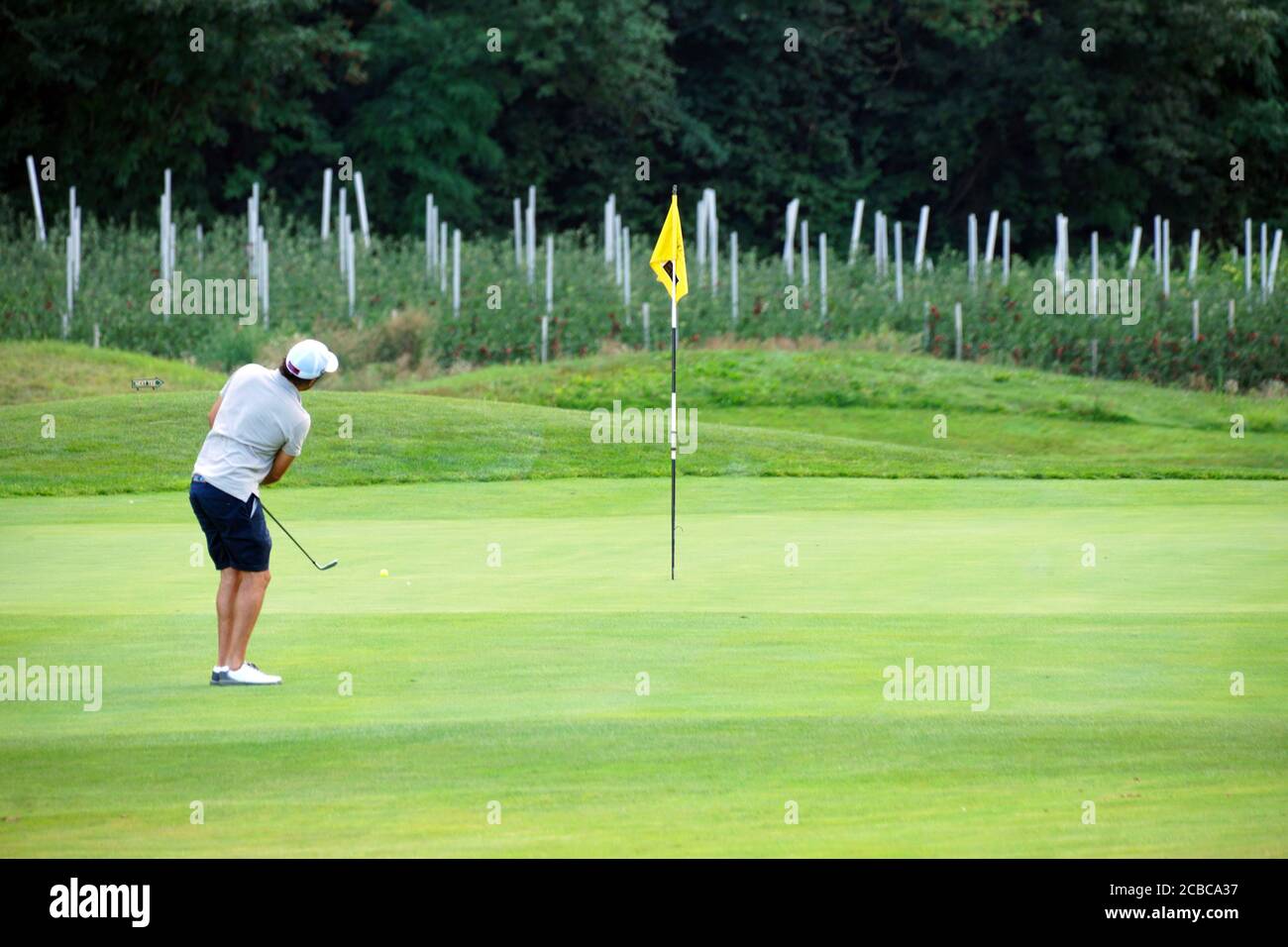 Blurred movement of a male golfer teeing-off at the Blue Monster golf club in South Tirol, Italy in summer of 2020. Stock Photo