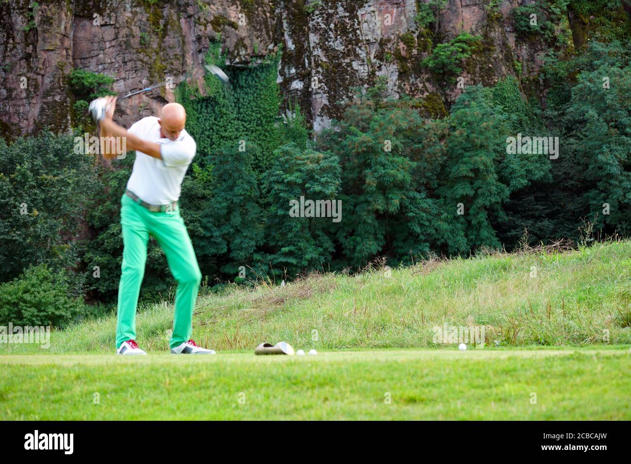 Blurred movement of a male golfer teeing-off at the Blue Monster golf club in South Tirol, Italy in summer of 2020. Stock Photo