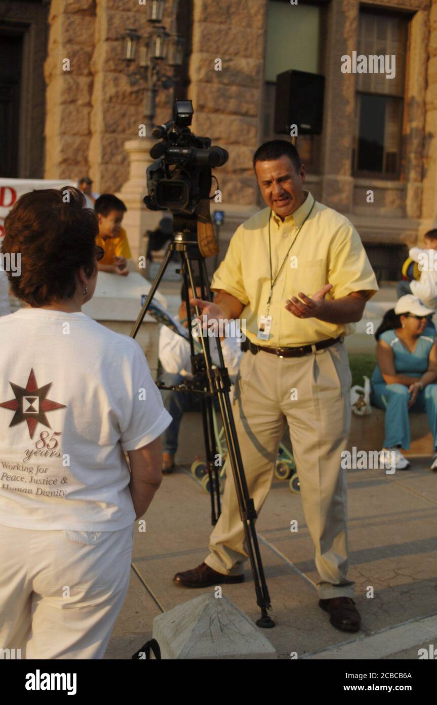 Austin, Texas USA, September 7, 2006: Hispanic television journalist from Austin's Time-Warner owned cable TV news station interviews a pro-immigration supporter at a rally at the Texas capitol.  ©Bob Daemmrich Stock Photo