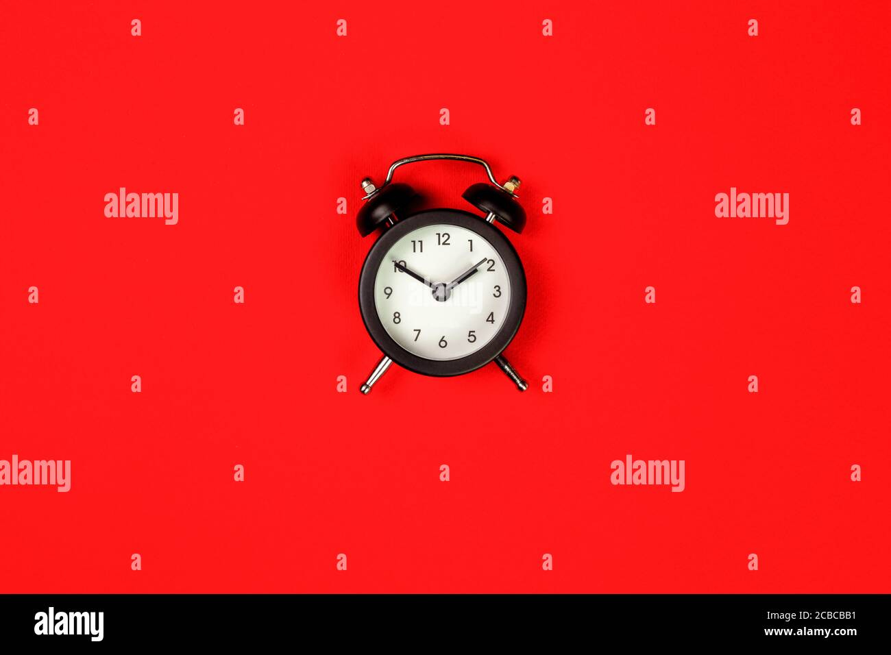 isolated black clock on red background, top view Stock Photo