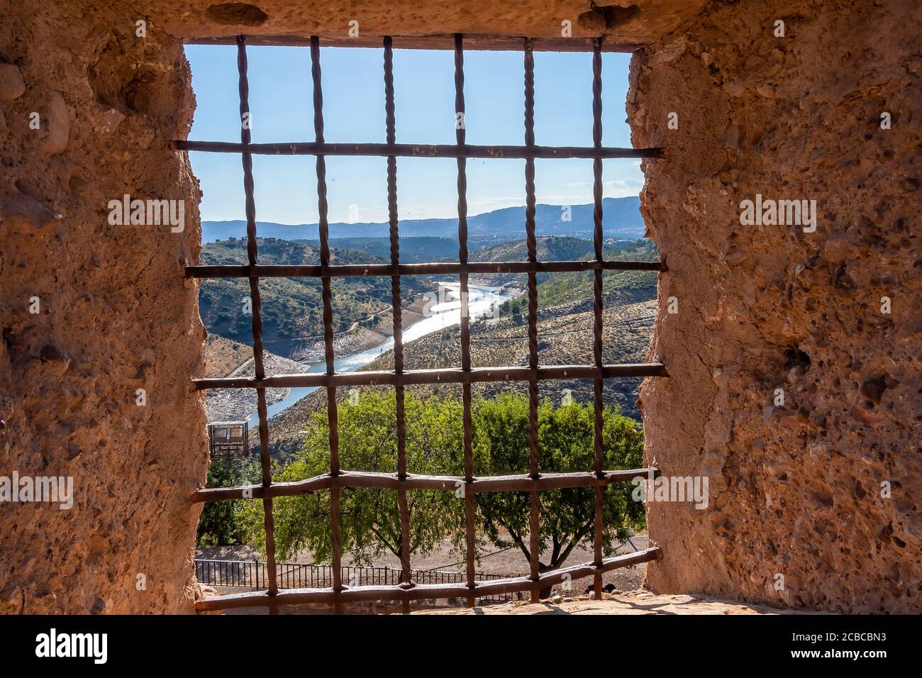 Views through a castle window with wrought iron grating (Castle grill) Stock Photo