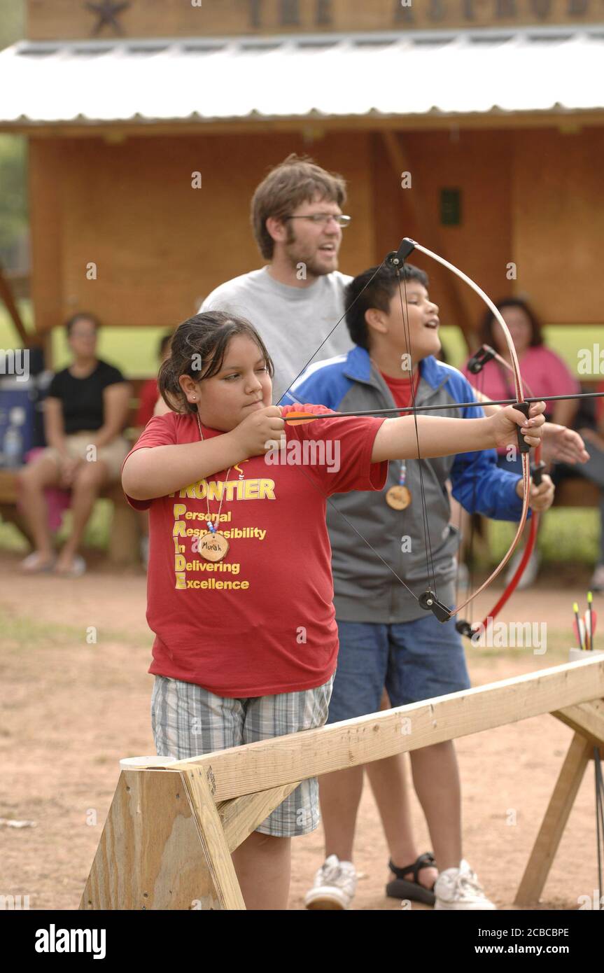 Granite Shoals, Texas USA, May 1, 2007: Twelve and 13-year-old Hispanic students from IDEA Academy, a Brownsville public charter school, experience a three-day outdoor education camp to help foster leadership and personal growth. Students learn basic archery skills with the help of counselors.  ©Bob Daemmrich Stock Photo