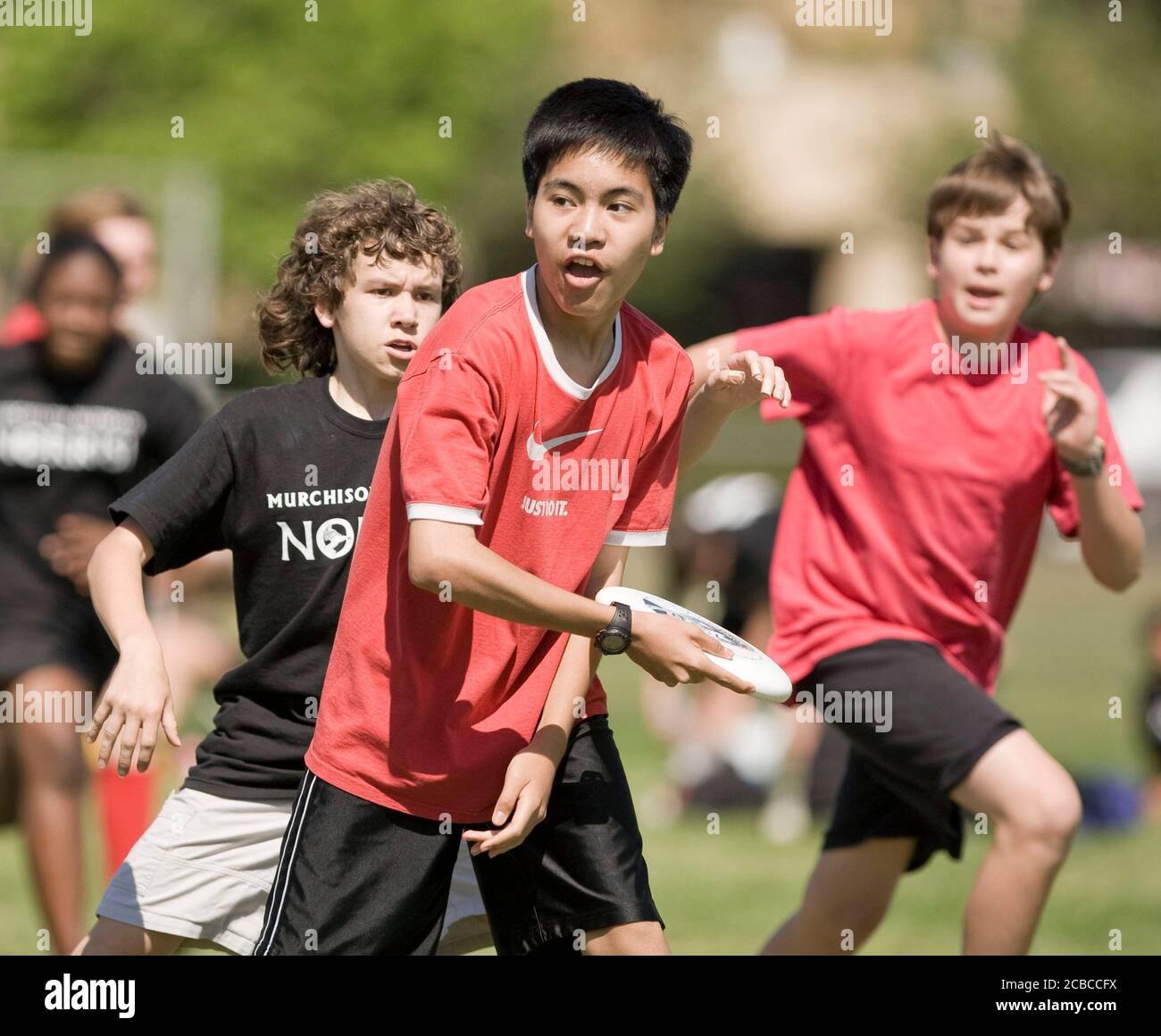 Austin, Texas USA, April 7, 2008: Middle school students from Murchison (black shirts) and Kealing (red shirts) play a competitive game of Ultimate on a spring Saturday afternoon. Each co-ed team starts seven players and uses a flying disc weighing 175 grams in competition.   ©Bob Daemmrich Stock Photo