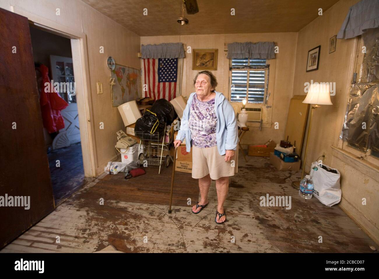 Galveston, Texas USA, September 27, 2008: More than two weeks after Hurricane Ike ravaged Galveston Island and east Texas, some Galveston residents are still living in squalor conditions. Patricia Aguilar, 75, of 1911 Avenue N on the east side, hds been sleeping on a damp and moldy mattress until volunteers from a church group came by to clear her house of rotting food and furnishings.    ©Bob Daemmrich Stock Photo