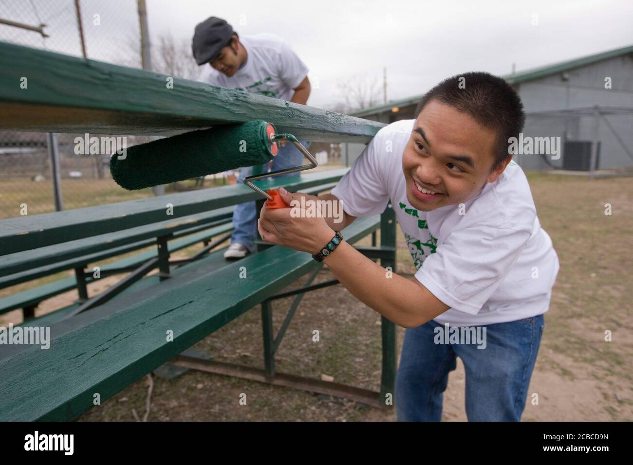 Austin, Texas USA, February 14, 2009: University of Texas at Austin students, including these members of  the Filipino-American Students Association, volunteer their time to paint bleachers in a public park in east Austin as part of the second-annual Clinton Global Initiative University, a conference bringing together students to take action on global challenges such as poverty, hunger, energy, climate change and global health. The program is patterned after Clinton Global Initiative Foundation formed by President Bill Clinton.       ©Bob Daemmrich Stock Photo