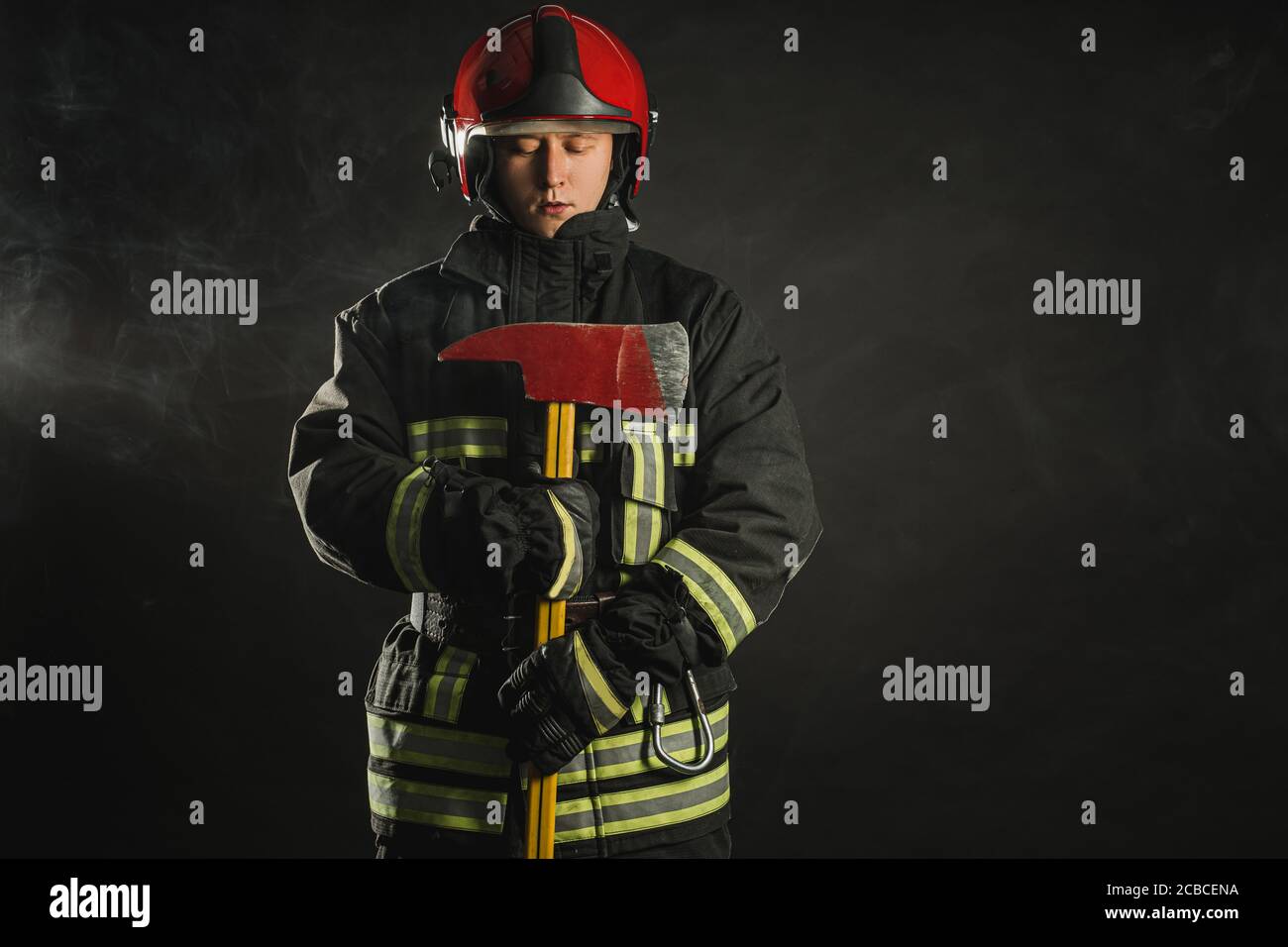 strong firefighter in protective suit and helmet use special equipment