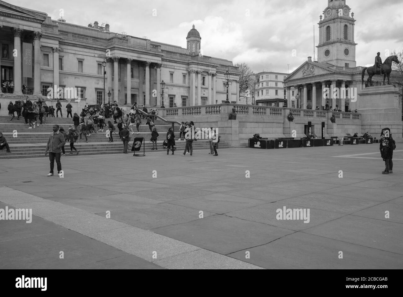 Black and white image and general view of Trafalgar Square London with the National Gallery museum and St Martin in the Fields in the background. Stock Photo