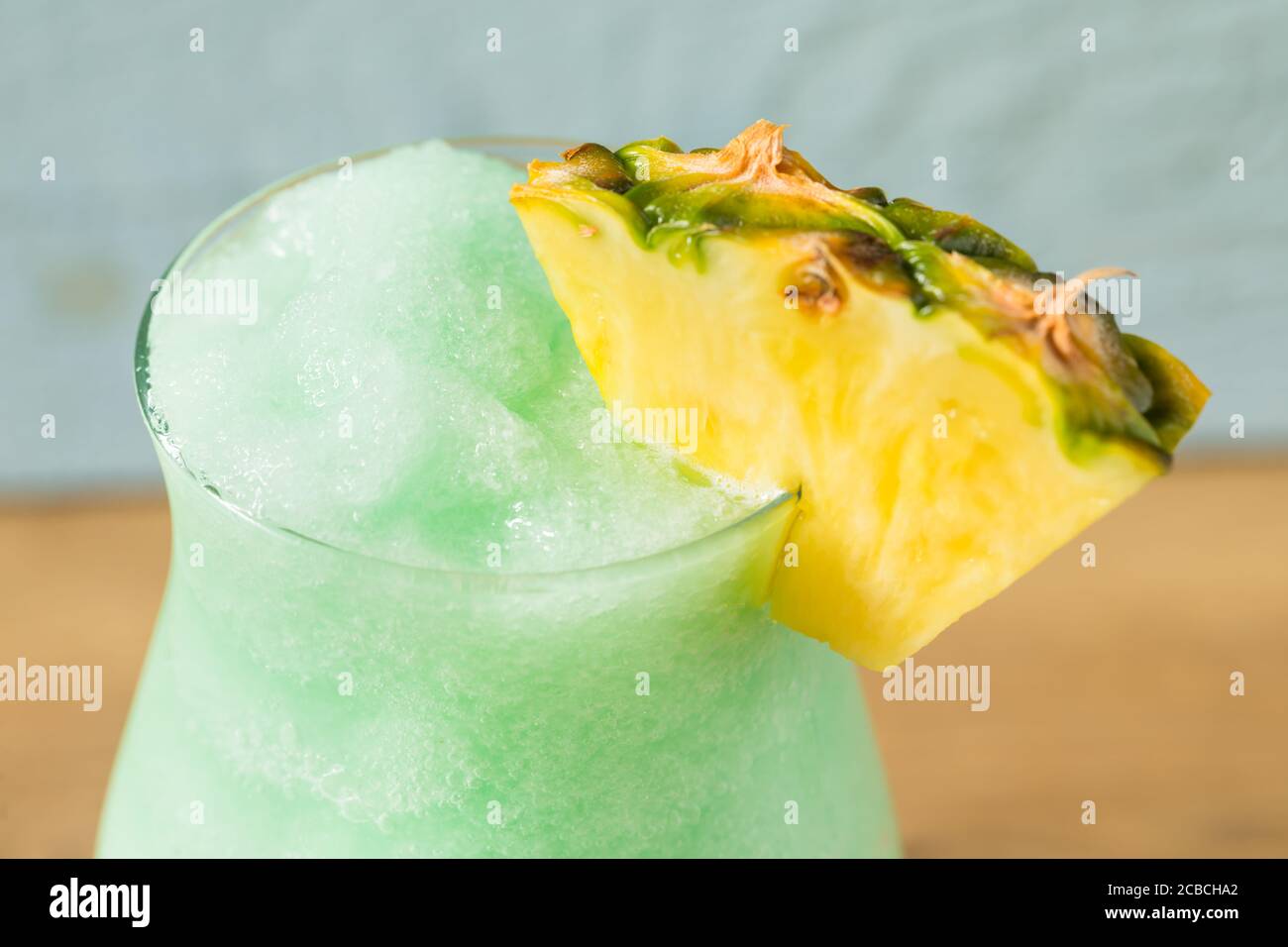 Boozy Frozen Blue Hawaii Cocktail with PIneapple and Curacao Stock Photo
