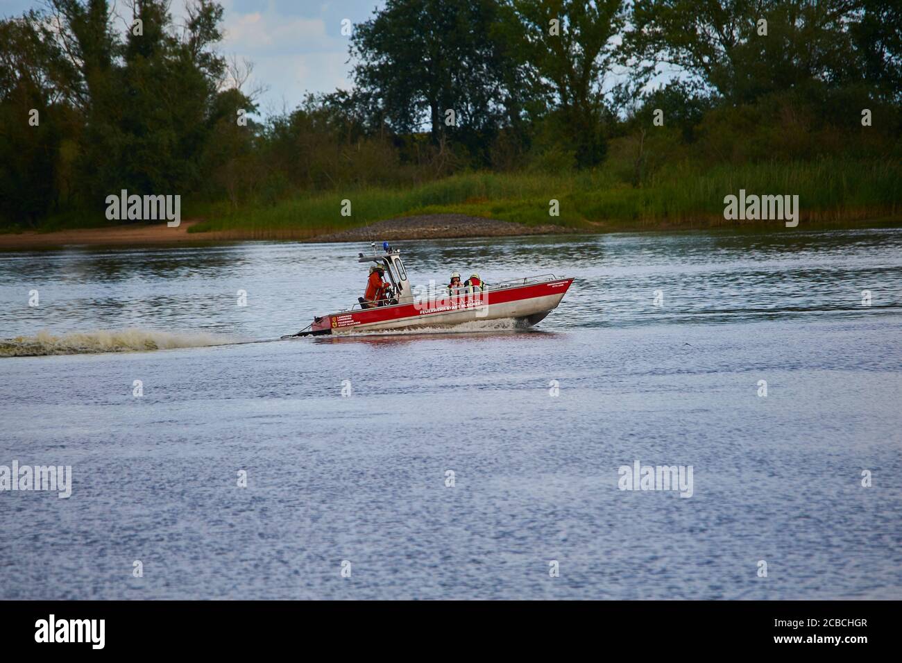 A fire-brigade boat dashing off for a an emergency rescue mission on river Elbe Stock Photo