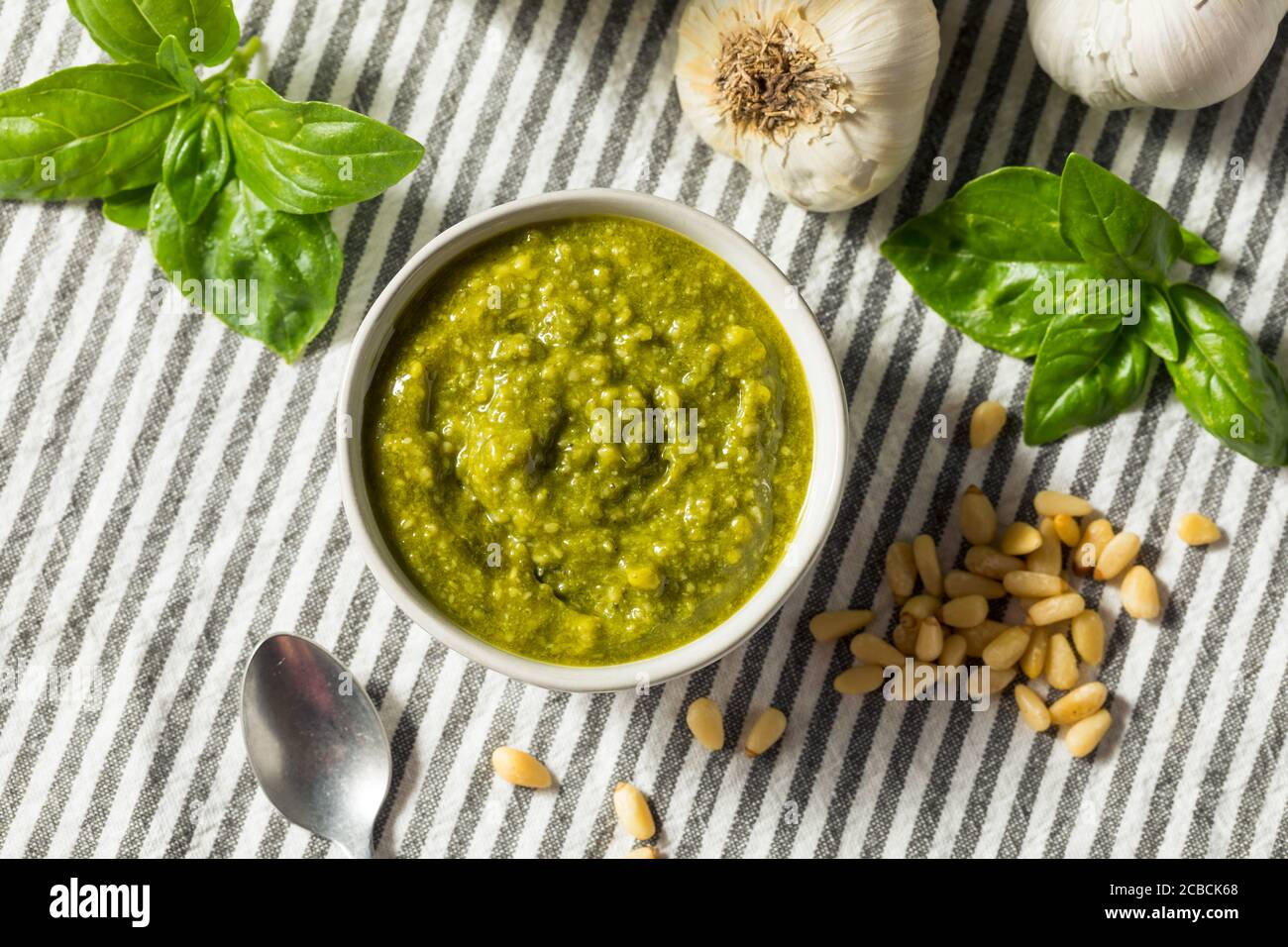 Fresh Green Organic Basil Pesto Sauce with Parmesan and Pine Nuts Stock Photo