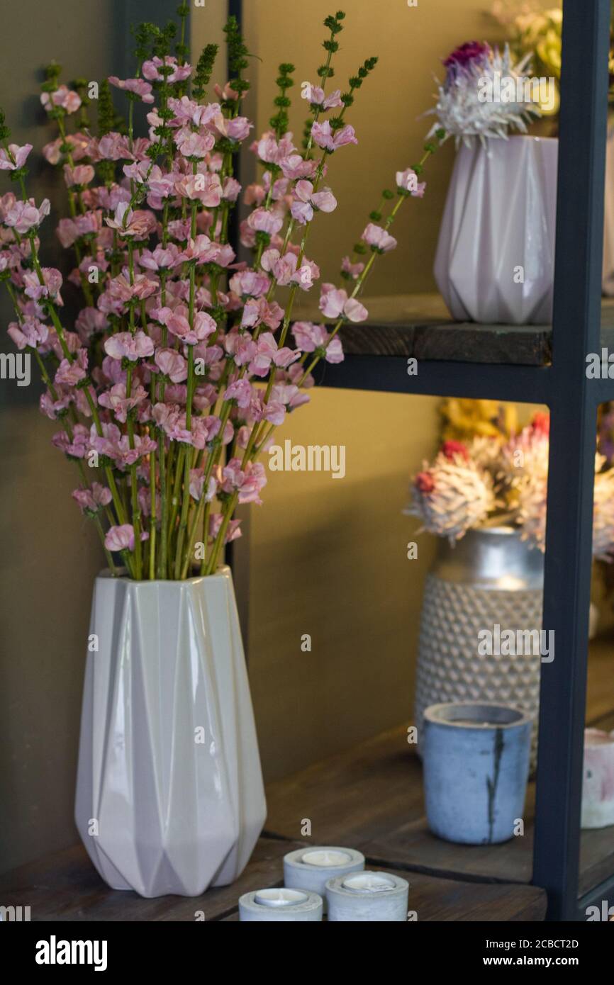 Florist shop interior, shelves with vases of dried flowers, bouquets of dried flowers, selective focus Stock Photo
