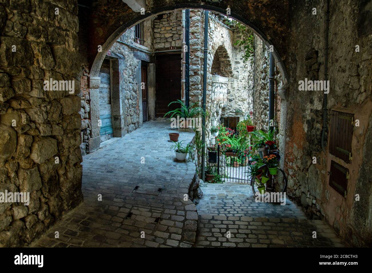 Flowered arch door in a medieval village of France. Tourette sur Loup, French Riviera Stock Photo