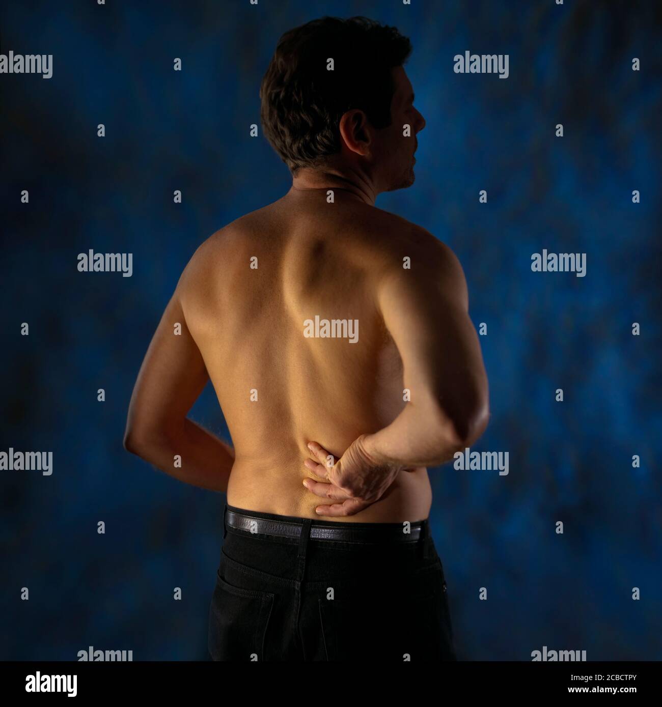 Man expressing back pain Stock Photo