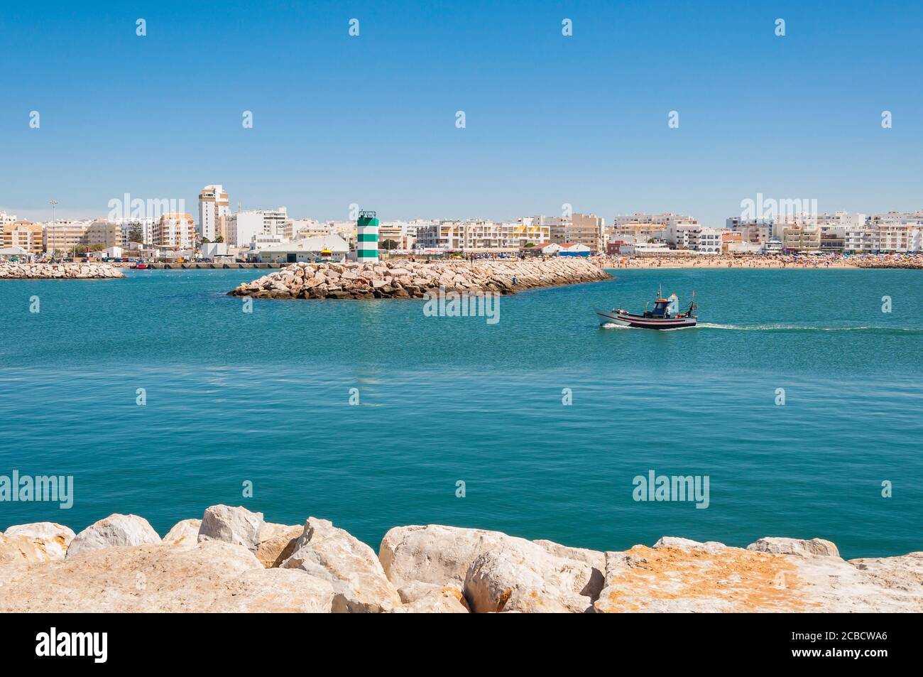 Fishboat enters the port of VIlamoura town, Algarve, Portugal Stock Photo