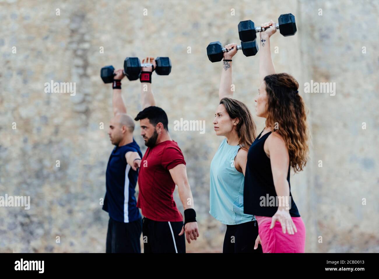 Athletes lifting crossfit weights in an urban enviroment Stock Photo