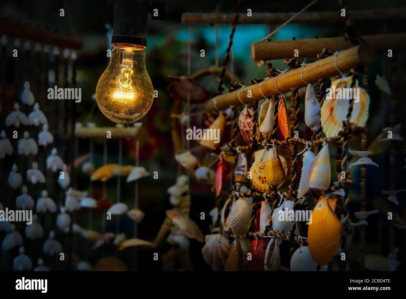 A light bulb shines on wind chimes in the port town of Jogashima, Japan, the southern most point on the Miura Peninsula. Stock Photo