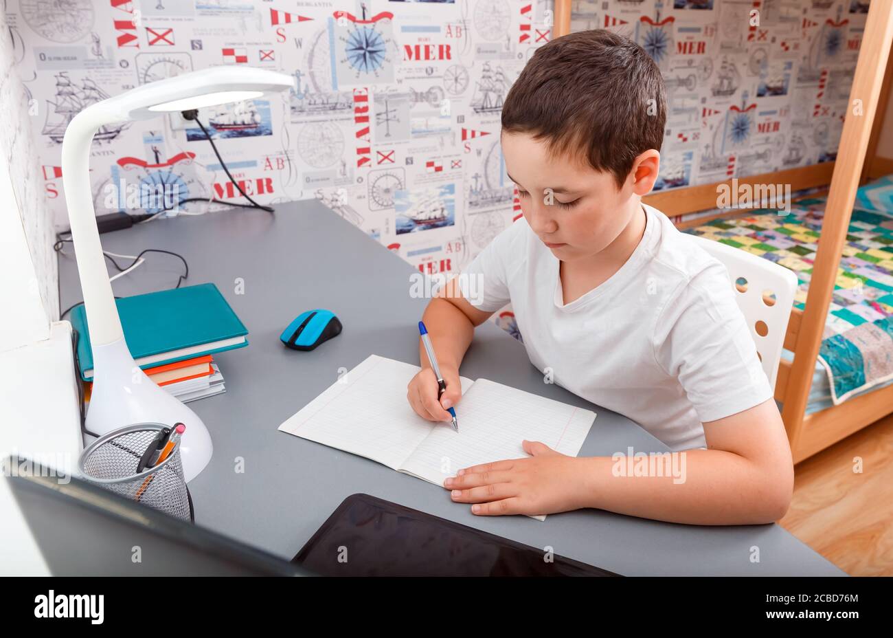 Schoolboy using desktop computer for online study homeschooling Stock Photo  - Alamy