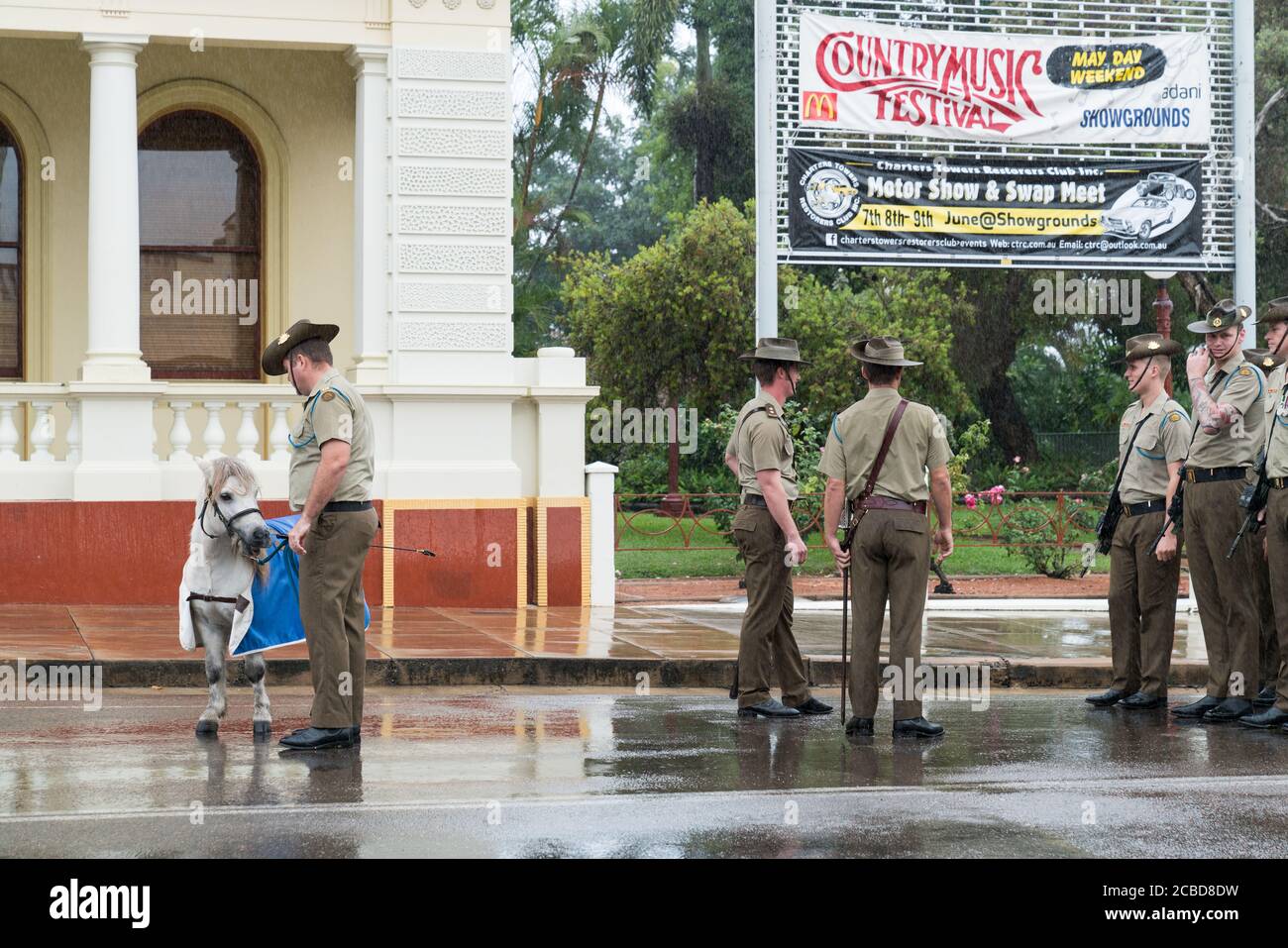 Charters Towers, Australia - April 25, 2019: Soldiers of the 1st Battalion, Royal Australian Regiment (1 RAR) preparing to march in the rain on Anzac Stock Photo