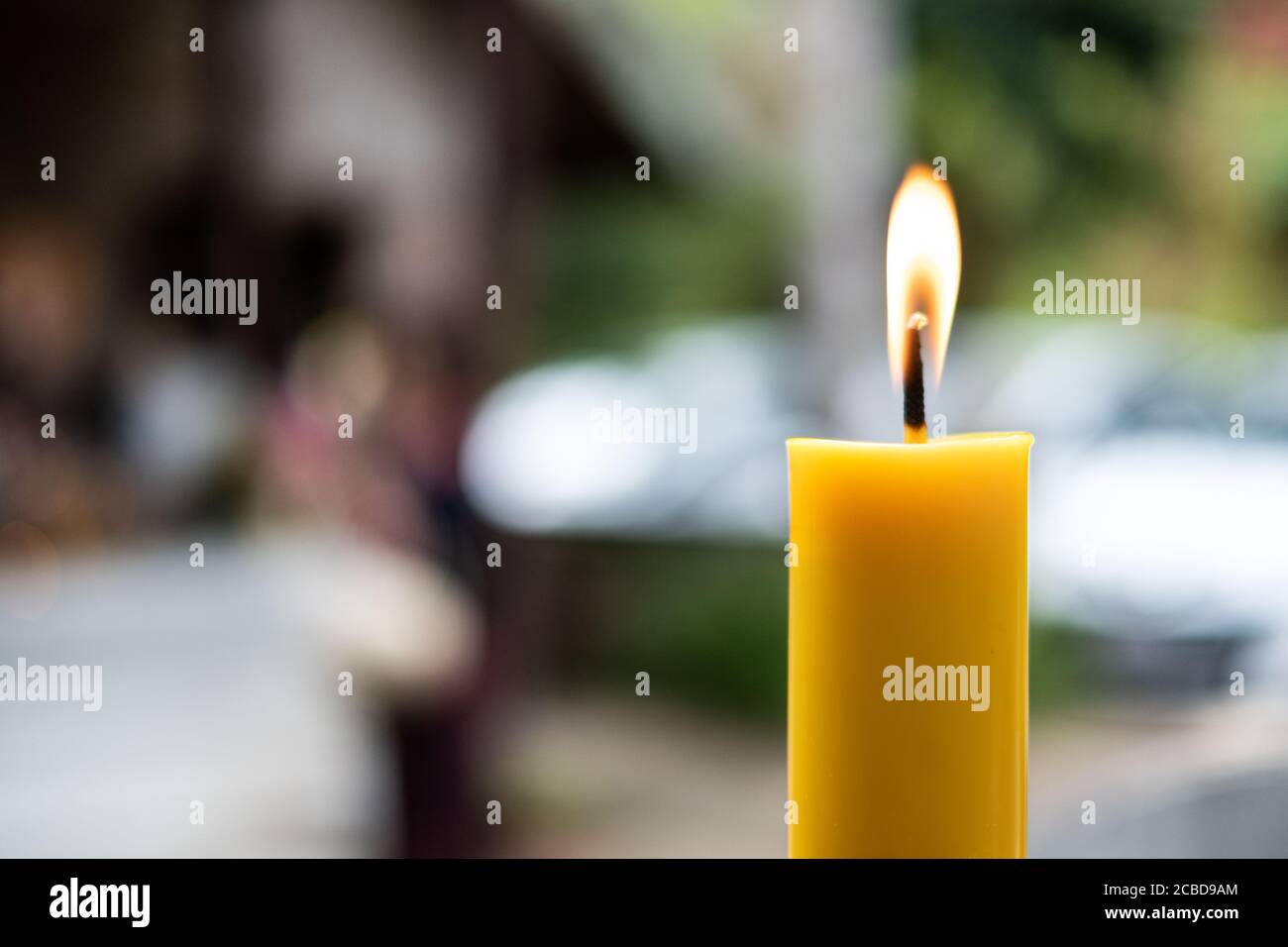 Light flame candle burning brightly on blurred background Stock Photo