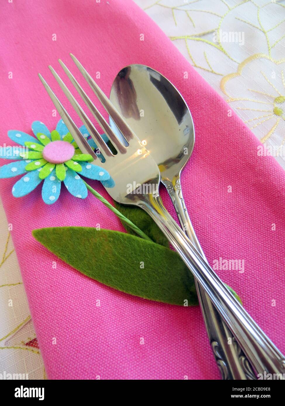 Silverware on a pink napkin Stock Photo - Alamy