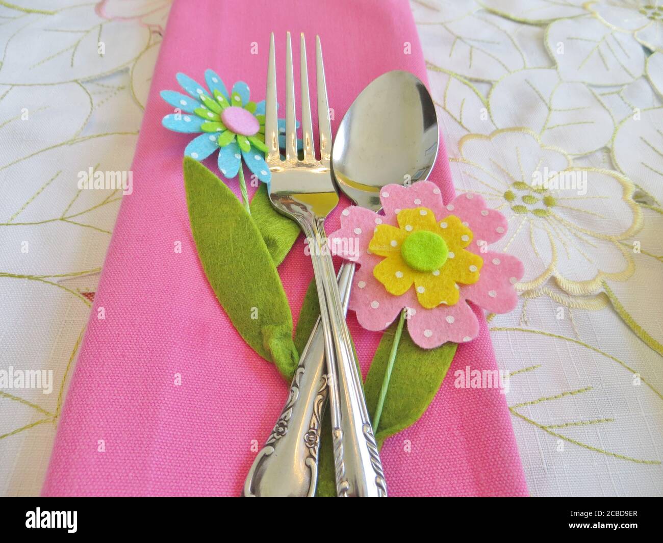 Silverware on a pink napkin Stock Photo - Alamy