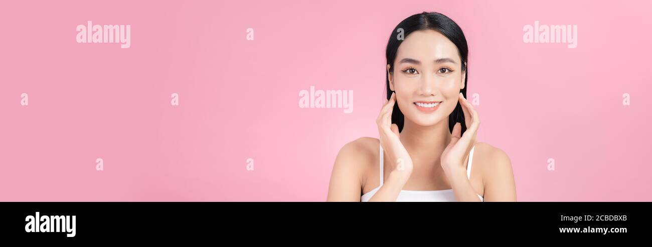 Beautiful Asian Girl touching her face and smiling, pampering her skin ...