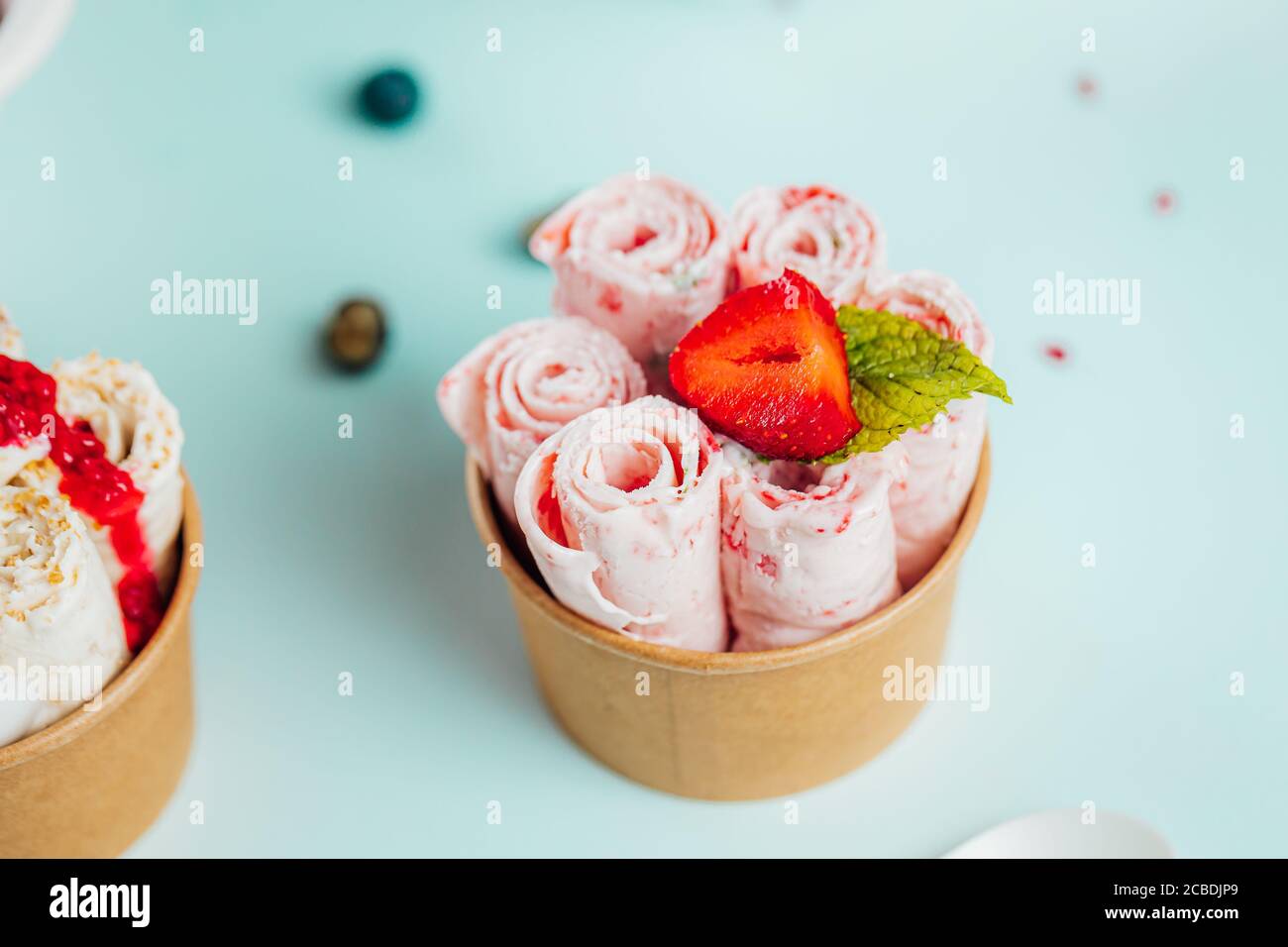 Closeup shot of the strawberry ice cream rolls in the container Stock