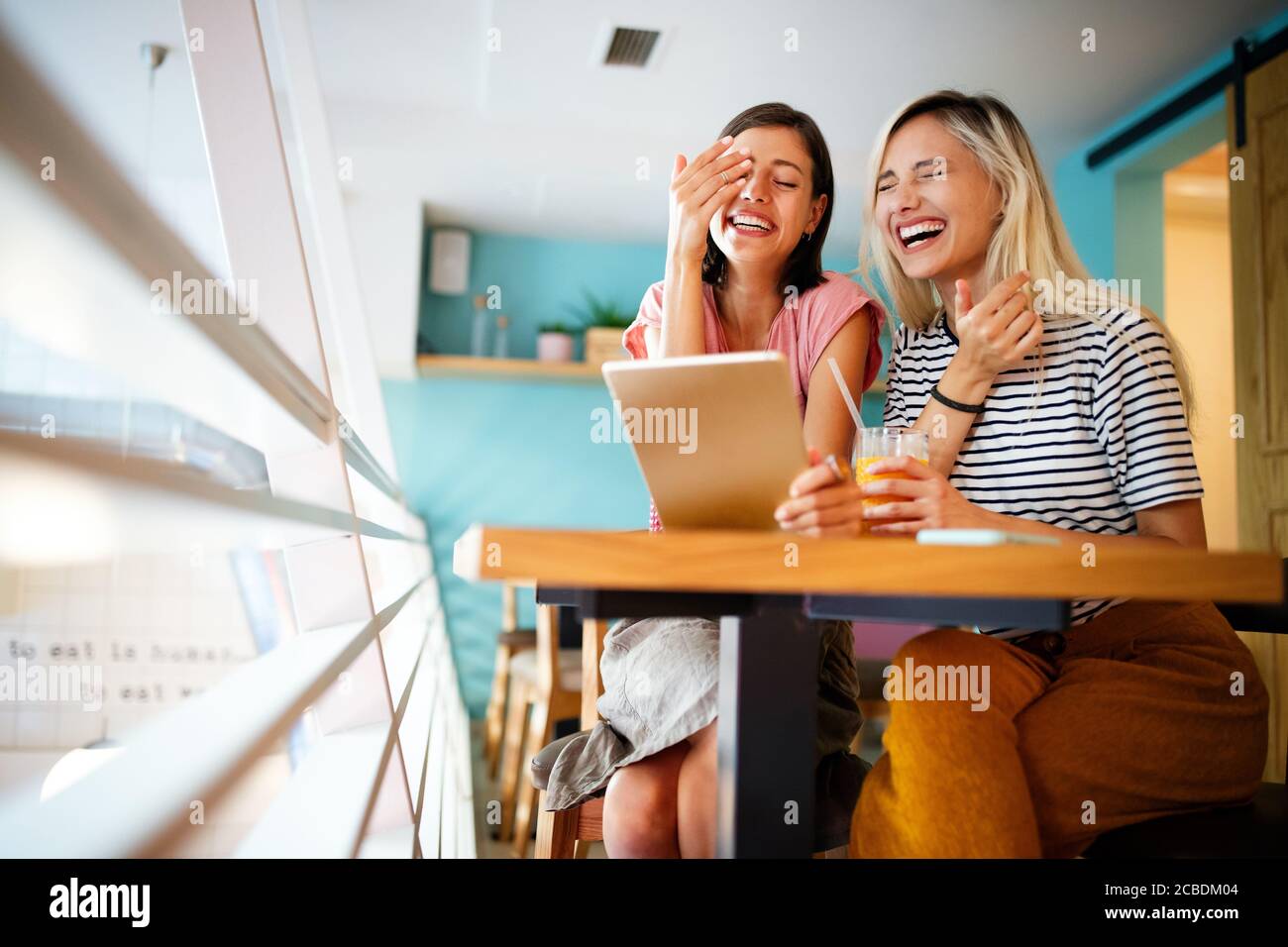 Happy beautiful women friends having fun, talking and smiling Stock Photo