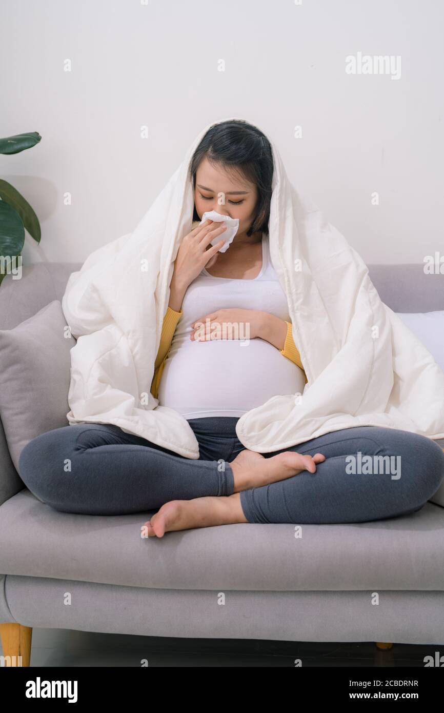 Pregnancy And Cold. Sick Pregnant Lady Blowing Nose In Tissue Feeling