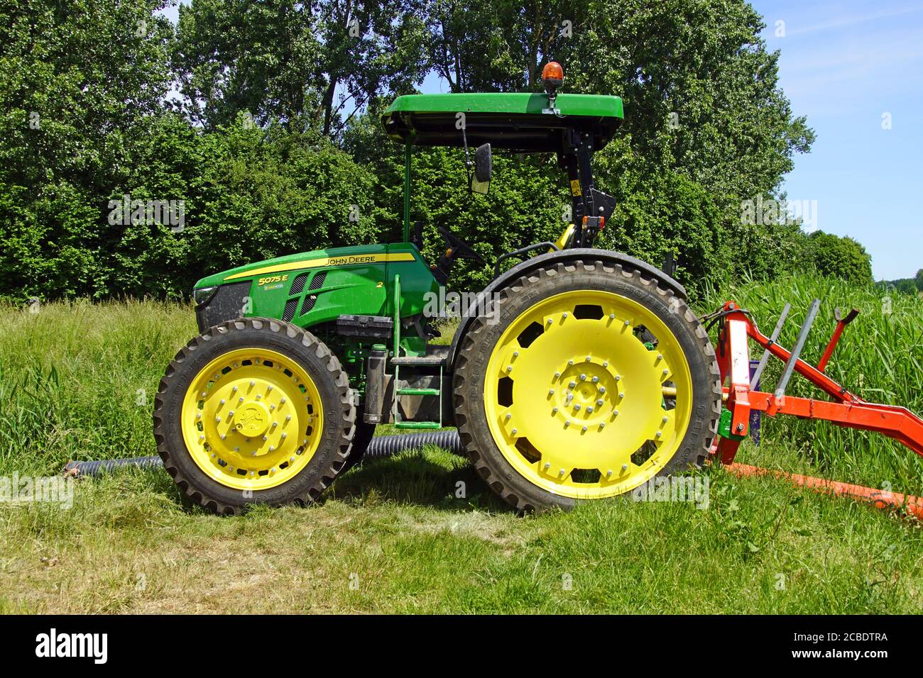 Almere, the Netherland - June 1, 2020: John Deere 5075 e standing on a field. Stock Photo