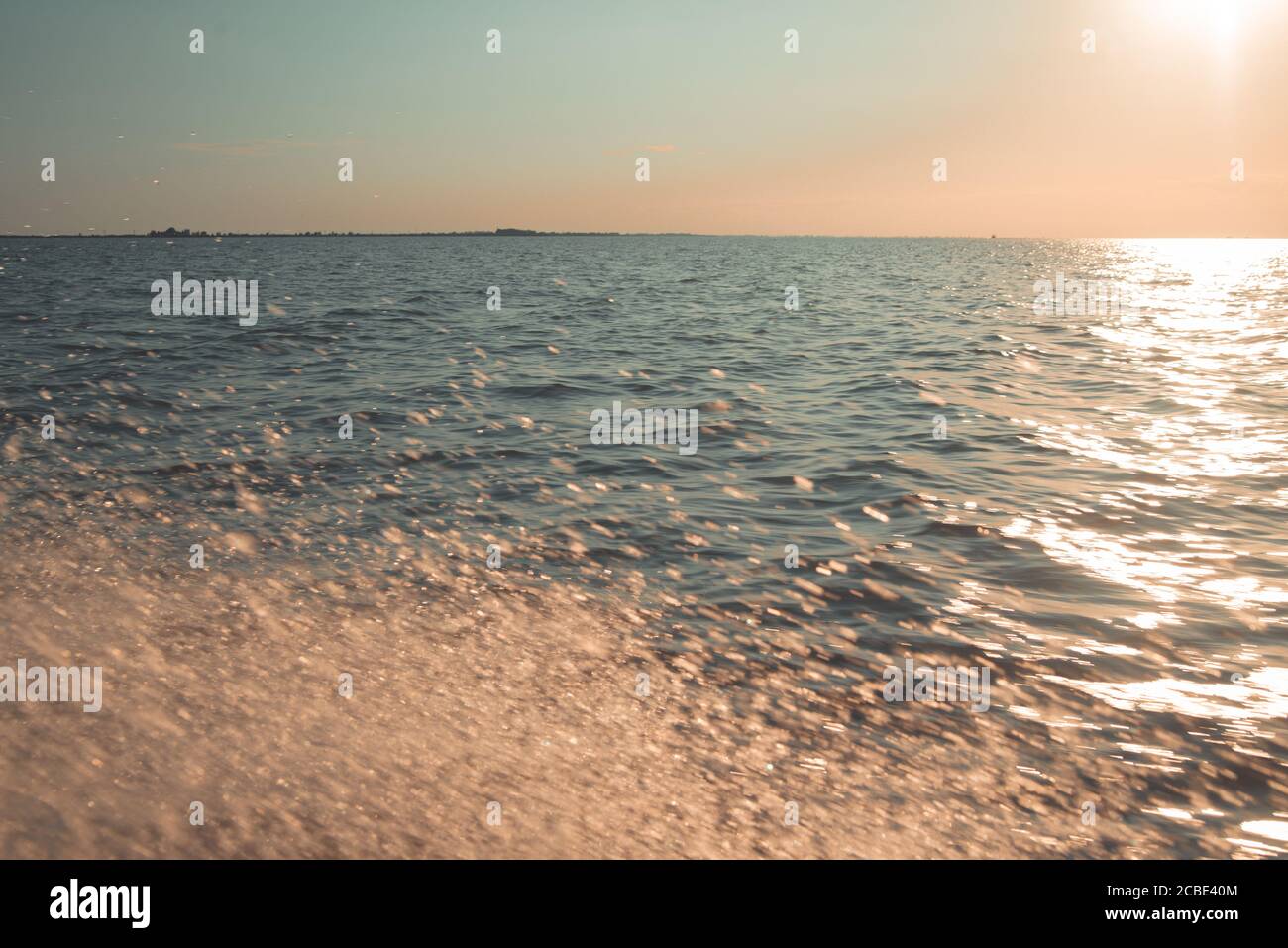 Splashes of water in the sea into the sunset, pastels colors Stock ...