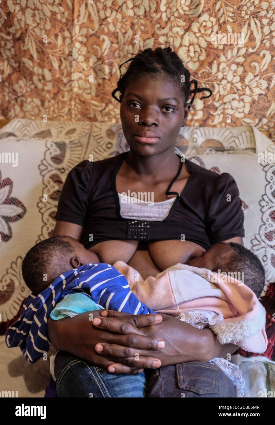 Nairobi, Kenya. 10th Aug, 2020. Sheila Sinsia, 22 year old single mother of two twins Kelsie Akinyi and Elsie Anyango is seen breastfeeding her two babies at her mothers house in Kibera Slums.Through breastfeeding, mothers in Kibera slums are able to protect their babies with a vital source of immune-boosting to enable the proper growth of their babies. Credit: SOPA Images Limited/Alamy Live News Stock Photo