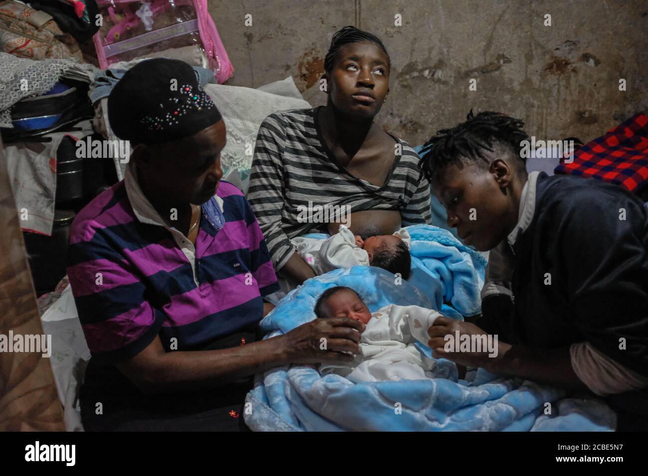 Nairobi, Kenya. 07th Aug, 2020. 19 year old single mother Rose Wateri is seen breastfeeding her twin daughters inside her house in Kibera Slums.Through breastfeeding, mothers in Kibera slums are able to protect their babies with a vital source of immune-boosting to enable the proper growth of their babies. Credit: SOPA Images Limited/Alamy Live News Stock Photo