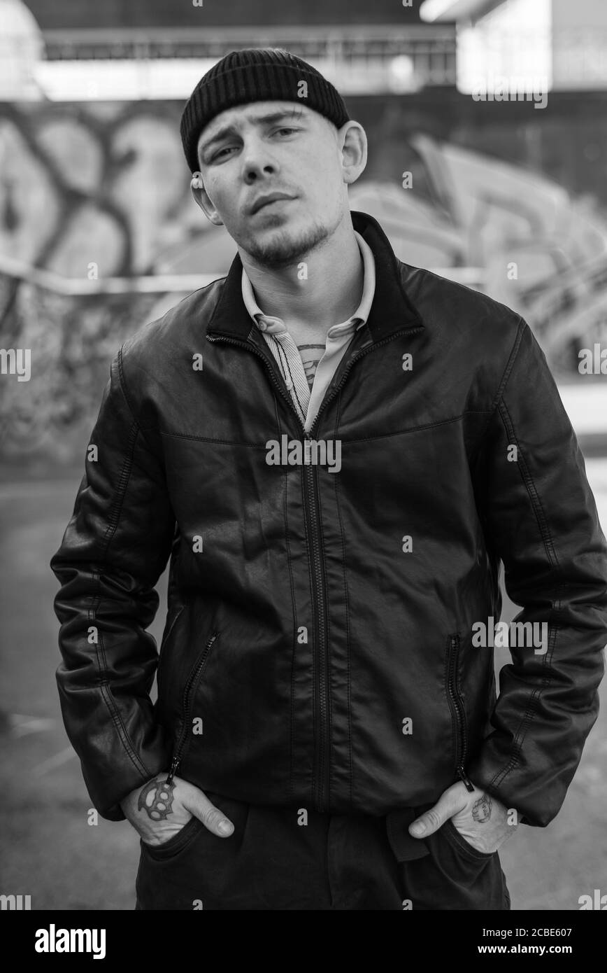 Bully criminal in black leather jacket. Black and white photo Stock Photo