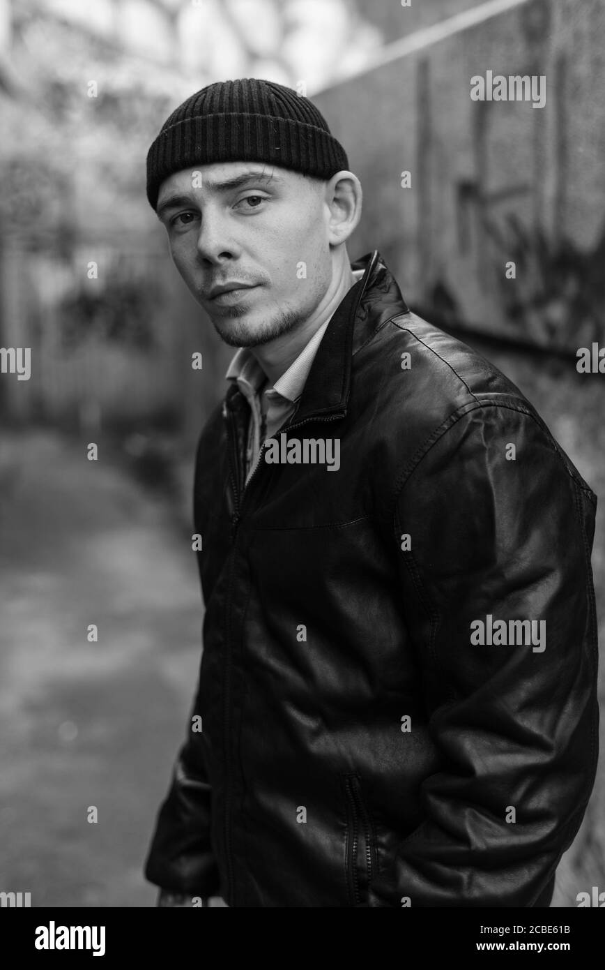 Bully criminal in black leather jacket. Black and white photo Stock Photo