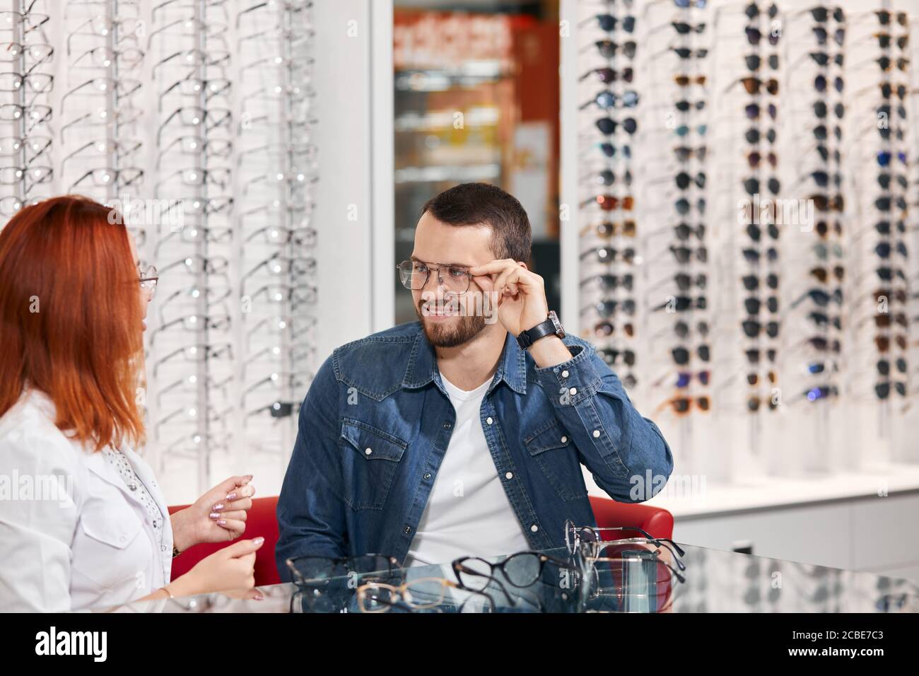 professional ginger oculist giving advice to a man, close up photo, profession, occupation . close up photo Stock Photo