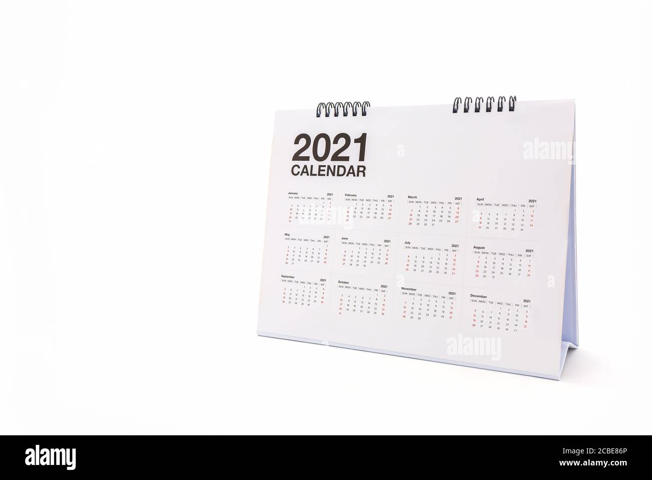 White paper desk spiral calendar 2021 on white background. Stock Photo