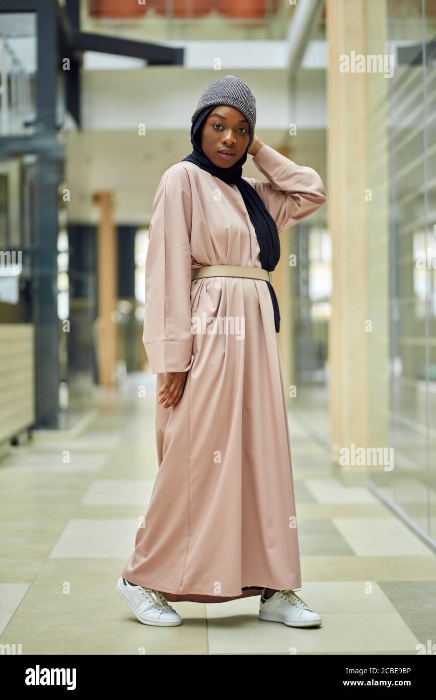 Beautiful young Muslim woman of african ethnicity dressed in pink long dress and black scarf posing in urban setting smiling at camera Stock Photo - Alamy Beautiful young Muslim woman of african ethnicity dressed in pink long dress and black scarf posing in urban setting smiling at camera Stock Photo - Alamy
