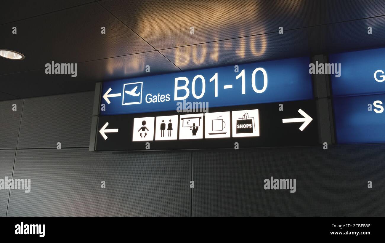 Blue terminal location indicators signs at the airport Stock Photo Alamy