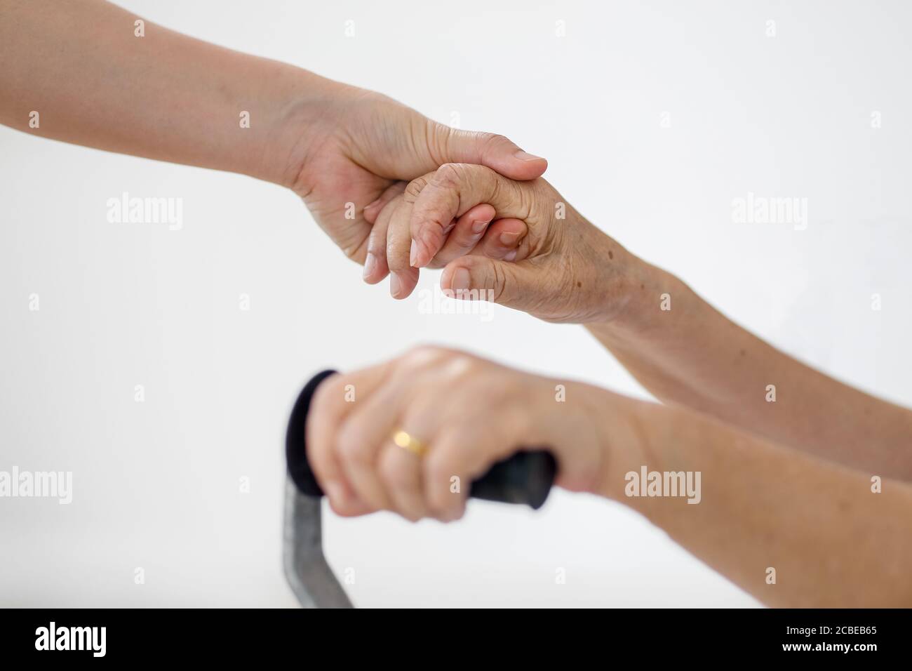 Elderly asian woman using a cane at home with caregiver take care Stock Photo