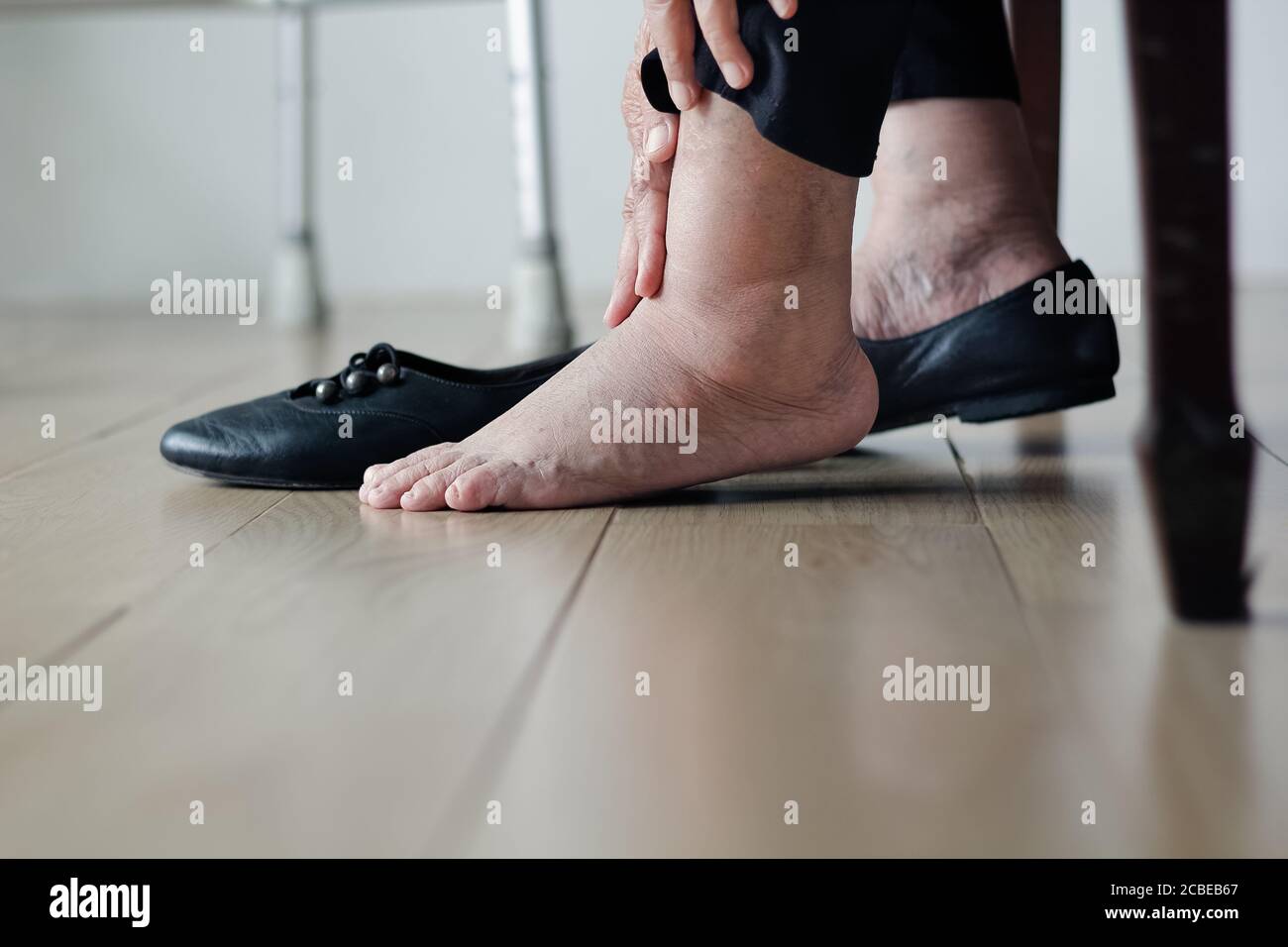 Elderly woman swollen feet putting on shoes Stock Photo Alamy