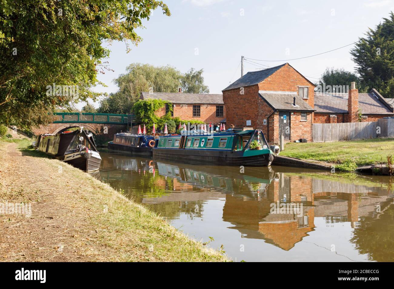 Crick, Northamptonshire, UK - 12/08/20: Narrowboats moored at Crick Wharf on the Grand Union Canal, a popular route for boating holidays. Stock Photo