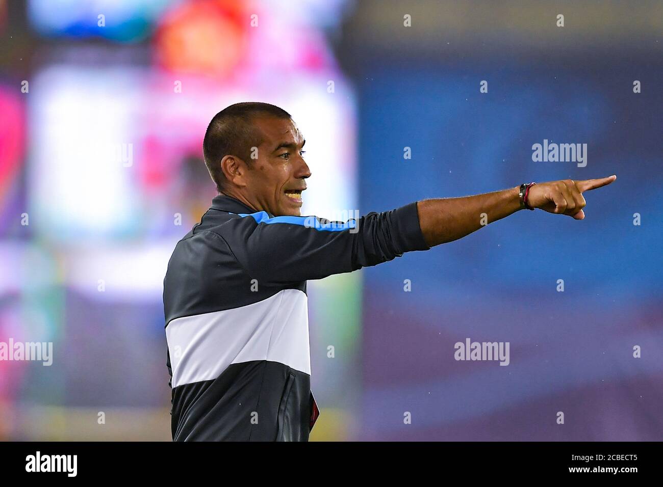 The manager of Guangzhou R&F Giovanni van Bronckhorst watches the third-round match of 2020 Chinese Super League (CSL) against Henan Jianye F.C., Dalian city, northeast China's Liaoning province, 5 August 2020. Henan Jianye F.C. and Guangzhou R&F F.C. drew the game with 1-1. Stock Photo