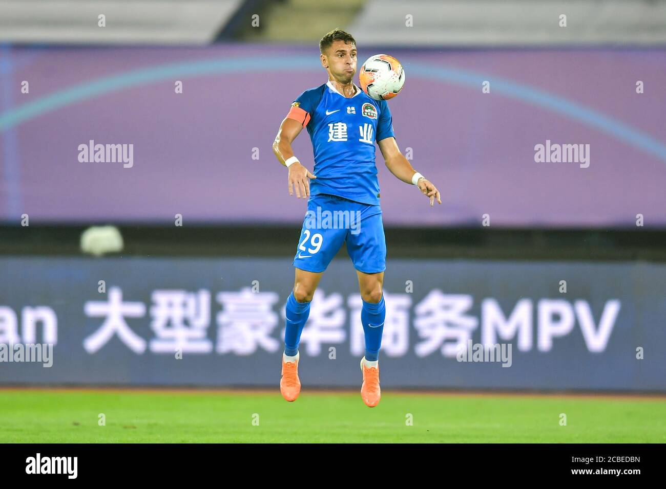 Brazilian football player Olivio da Rosa, also known as Ivo, of Henan Jianye F.C. stops the ball during the fourth-round match of 2020 Chinese Super League (CSL) against Shenzhen F.C., Dalian city, northeast China's Liaoning province, 10 August 2020. Shenzhen F.C. was defeated by Henan Jianye F.C. with 1-2. Stock Photo