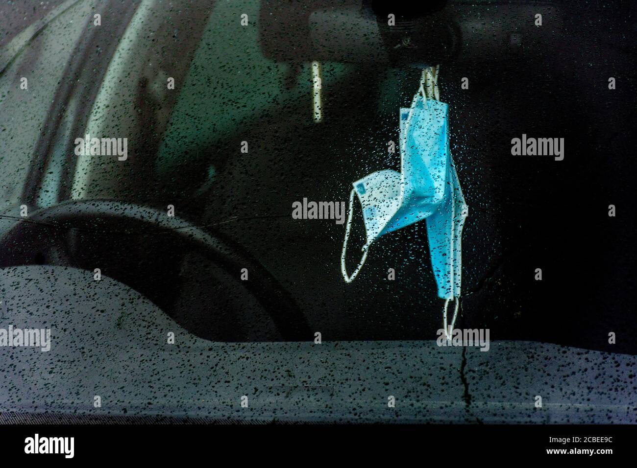 Ardara, County Donegal, Ireland. 13th August 2020. Facemasks are seen hanging from the rearview mirror of a car on a rainy day on the north-west coast. Sign of the times during the Covid-19, Coronavirus pandemic. Stock Photo