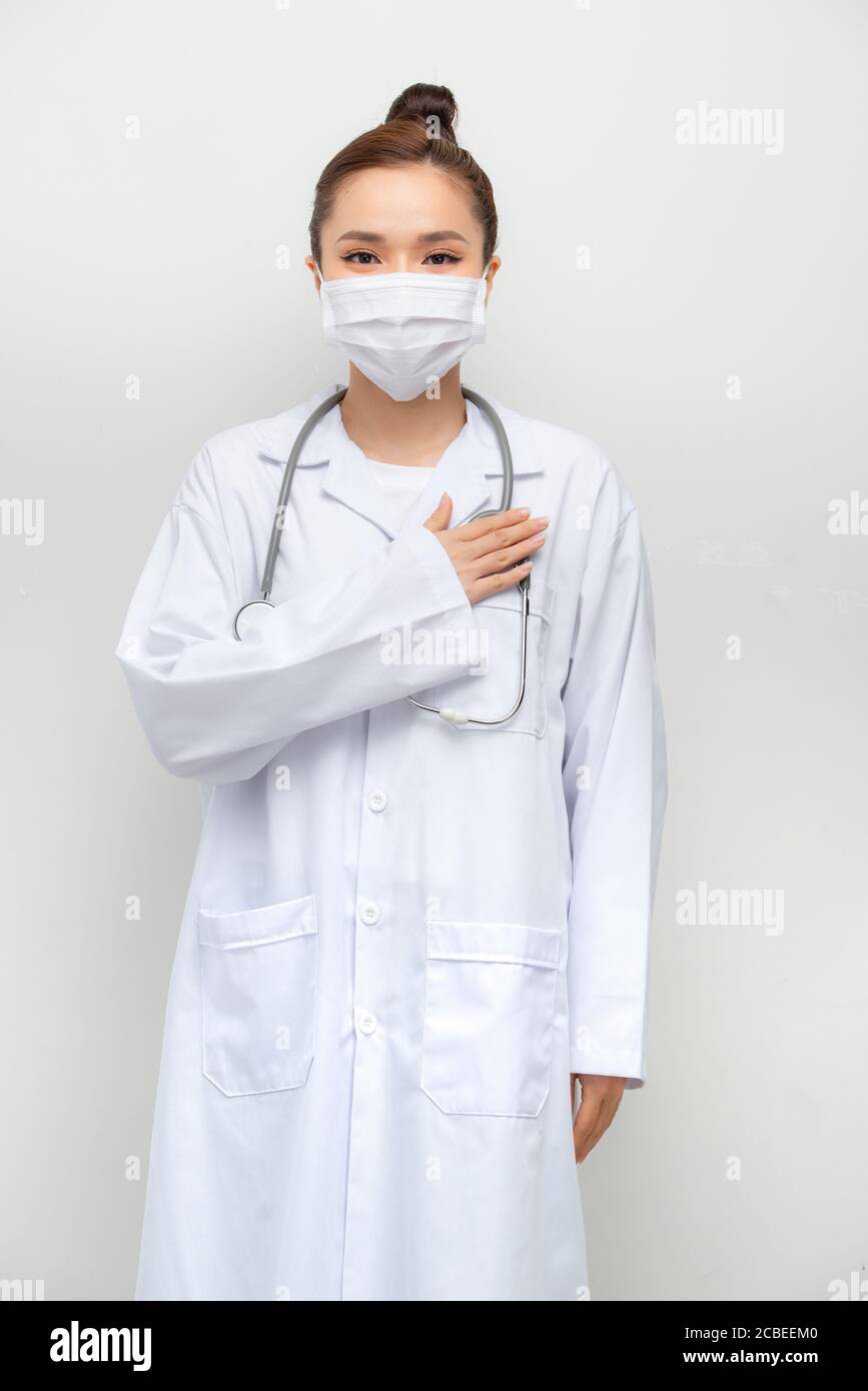 Young african american doctor woman over isolated background smiling with hands on chest Stock Photo